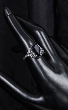 "I'll love you to the tomb and back." Unleash your inner gothic glamour with this stunning ring shaped like a coffin, with the centre featuring a gorgeous black gem, making for a beautifully intricate and unique addition to any outfit. Details: Material: Zinc Alloy Measurements: 1cm wide x 1.5cm tall. Size: Size 7, 8 or 9. Colour: Silver & Black. Coffin Engagement Ring, Goth Rings, Gothic Glamour, Black Gems, Witchy Jewelry, Victorian Rings, Ring Shapes, Victorian Gothic, Gothic Jewelry