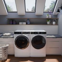 a washer and dryer sitting in a room with skylights above it's windows