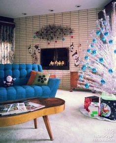 a living room filled with furniture and a christmas tree in front of a fire place