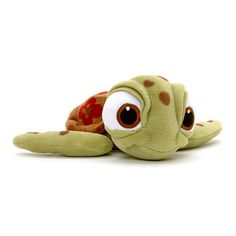 a stuffed turtle with big eyes laying down