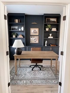 an office with built in bookcases and a desk