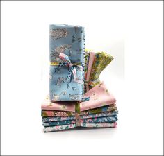 a stack of folded cloths on top of each other in different colors and patterns