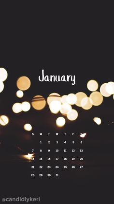 a calendar with the word january on it and bokeh lights in the background