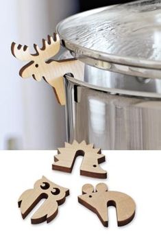 wooden cutouts of animals in front of a metal pot