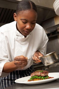 a female chef is preparing food in the kitchen stock photo - 958972