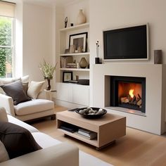 a living room filled with furniture and a fire place next to a flat screen tv