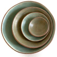 three green bowls stacked on top of each other