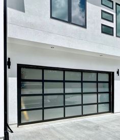 a black and white garage door on the side of a building