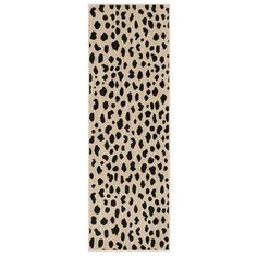 an animal print rug with black and white spots on the bottom, in front of a white background