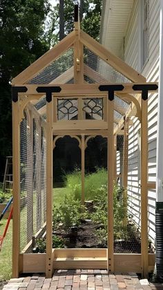 a wooden gazebo sitting on top of a brick patio