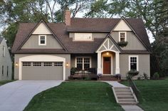 a large house with two garages in the front yard