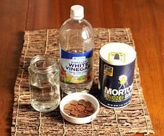 the ingredients to make white vinegar are displayed on a woven place mat, along with two glass jars