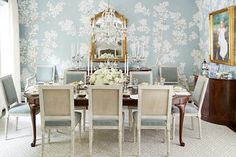 a dining room table with chairs and a chandelier