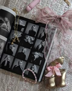 an open book on a bed next to a pair of pink shoes and a necklace