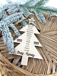 a wooden christmas tree ornament sitting on top of a wicker basket