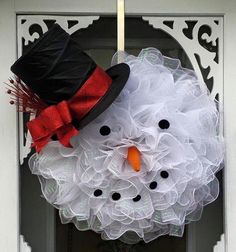 a snowman wreath hanging on the front door