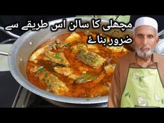 a man standing in front of a pan filled with food