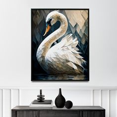 a painting of a white swan is hanging on the wall next to a black vase