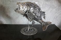 a metal fish sculpture sitting on top of a table