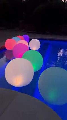 some lights that are on the side of a swimming pool