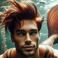 a man with red hair standing in front of an underwater background and looking at the camera