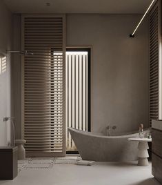 a bathroom with a bathtub, sink and window blinds in shades of brown on the wall