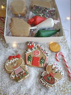 gingerbread cookies in a box with candy canes and candies on the table