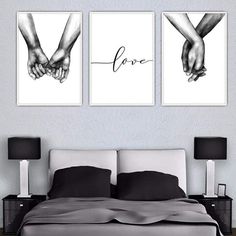 two black and white prints on the wall above a bed