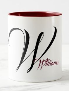 a white and red coffee mug with the letter w on it