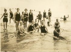 an old black and white photo of people in the water