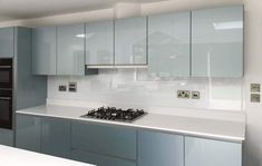 a kitchen with blue cabinets and white counter tops