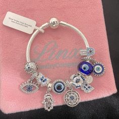 a bracelet with evil eyes and charms on it