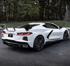 a white sports car parked on the street