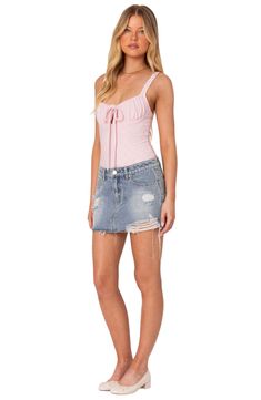 An on-trend low-rise cut defines this nonstretch-denim skirt featuring allover distressing for a chic lived-in look. Zip fly with button closure Five-pocket style 100% cotton Machine wash, dry flat Imported Fitted Denim Skirt With Frayed Hem For Summer, Chic Fitted Jean Shorts With Frayed Hem, Trendy Distressed Mini Skirt, Ripped Cutoff Mini Skirt, Ripped Fitted Cutoff Mini Skirt, Ripped High-rise Fitted Mini Skirt, Ripped Cutoff Mini Skirt For Summer, Fitted Ripped Cutoff Mini Skirt, Fitted High Waist Distressed Mini Skirt