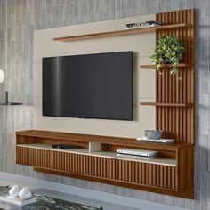 a flat screen tv mounted to the side of a wooden entertainment center in a living room