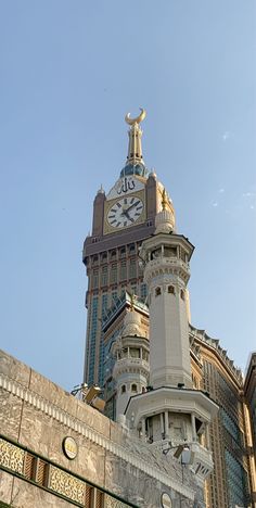 a large building with a clock on it's face in front of a blue sky