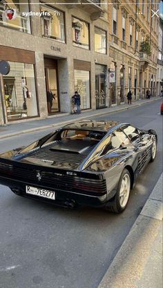 a black sports car parked on the side of a street