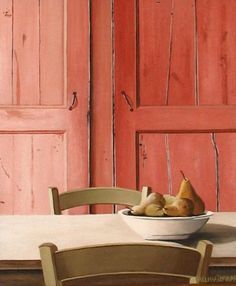 a bowl of fruit sitting on top of a table next to a wooden chair and red door