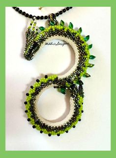 two bracelets with green and white beads on them, one is shaped like a snake