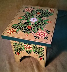 an intricately painted wooden box on a bed