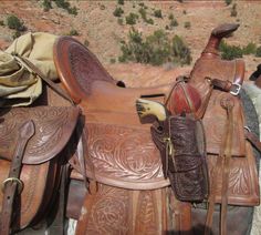 two saddles are sitting in the desert