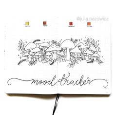 an open notebook with the words mood trackerr written in black ink on top of it