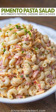 a white plate topped with pasta and ham