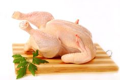 raw chicken sitting on a cutting board with parsley next to it stock images and clippings