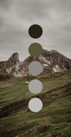 a group of circles hanging from the side of a mountain