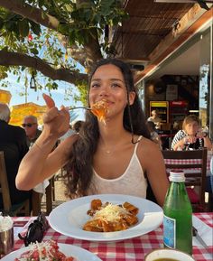 a woman sitting at a table eating food