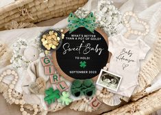 a baby announcement surrounded by items such as shoes, t - shirts and other items