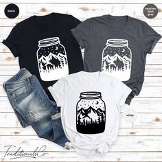 🌟 New T-Shirt Alert! 🌟 Hey there, fashion enthusiasts! 👋 Introducing our latest design: the Mountain Night Sky Tee! 🏔️✨ This stunning graphic captures the beauty of the mountains under a starlit sky, all within a charming mason jar. Perfect for nature lovers and adventure seekers alike! 🌲🌌 Pair it with your favorite jeans for a casual, yet stylish look. 👖 Don't miss out! Grab yours now and let the mountains inspire your everyday adventures. 🌟 Graphic Tee Shirt With Screen Print For Adventure, Black Graphic Print T-shirt For Adventure, Casual Adventure T-shirt With Custom Print, Black Graphic Print T-shirt For Camping, Casual Text Print T-shirt For Hiking, Adventure Shirt, Vacation Shirts, New T, Favorite Jeans