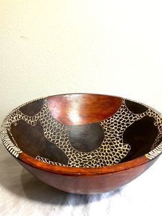 a wooden bowl sitting on top of a table