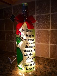 a lighted bottle with dr seuss's christmas message on it